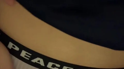 Asian woman exposes midriff and underwear